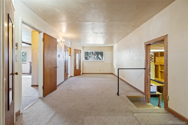 spare room featuring light colored carpet and a wealth of natural light