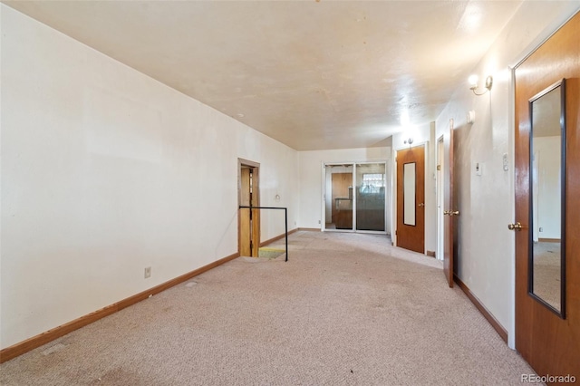 empty room featuring light carpet