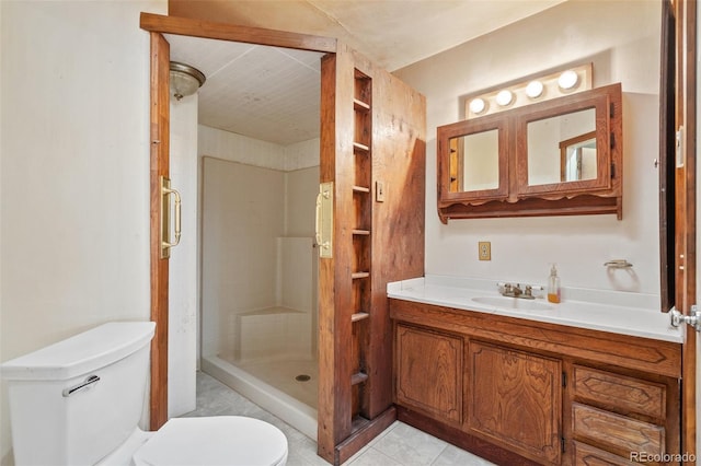 bathroom with tile patterned flooring, vanity, toilet, and a shower