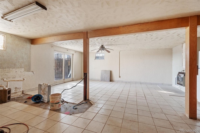 interior space featuring ceiling fan, light tile patterned flooring, and heating unit