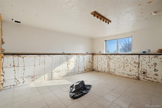 7615 Maverick Rd, Colorado Springs, CO 80908 - spare room featuring a wainscoted wall and tile patterned flooring