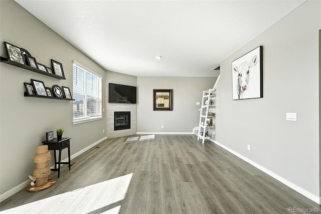 1670 Vantage Pkwy, Berthoud, CO 80513 - unfurnished living room with wood finished floors and a glass covered fireplace