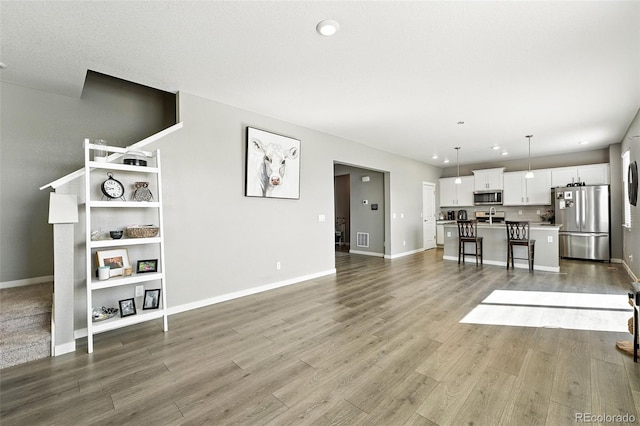 1670 Vantage Pkwy, Berthoud, CO 80513 - living area with wood finished floors and recessed lighting