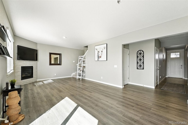 1670 Vantage Pkwy, Berthoud, CO 80513 - unfurnished living room with wood finished floors, a glass covered fireplace, and recessed lighting