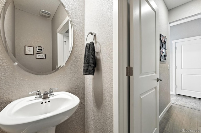 1670 Vantage Pkwy, Berthoud, CO 80513 - bathroom with a textured wall and wood finished floors
