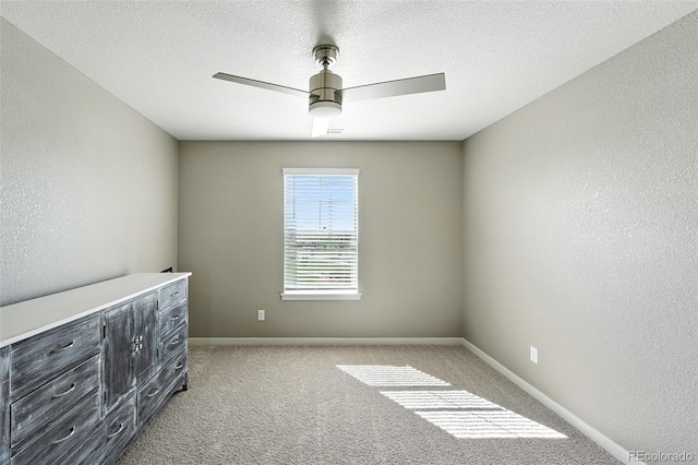 1670 Vantage Pkwy, Berthoud, CO 80513 - unfurnished bedroom featuring light colored carpet, a ceiling fan, a textured wall, and a textured ceiling
