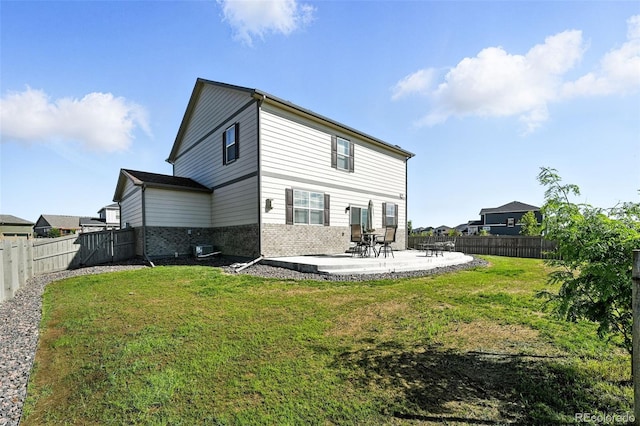 1670 Vantage Pkwy, Berthoud, CO 80513 - rear view of property with brick siding, a patio area, and a fenced backyard