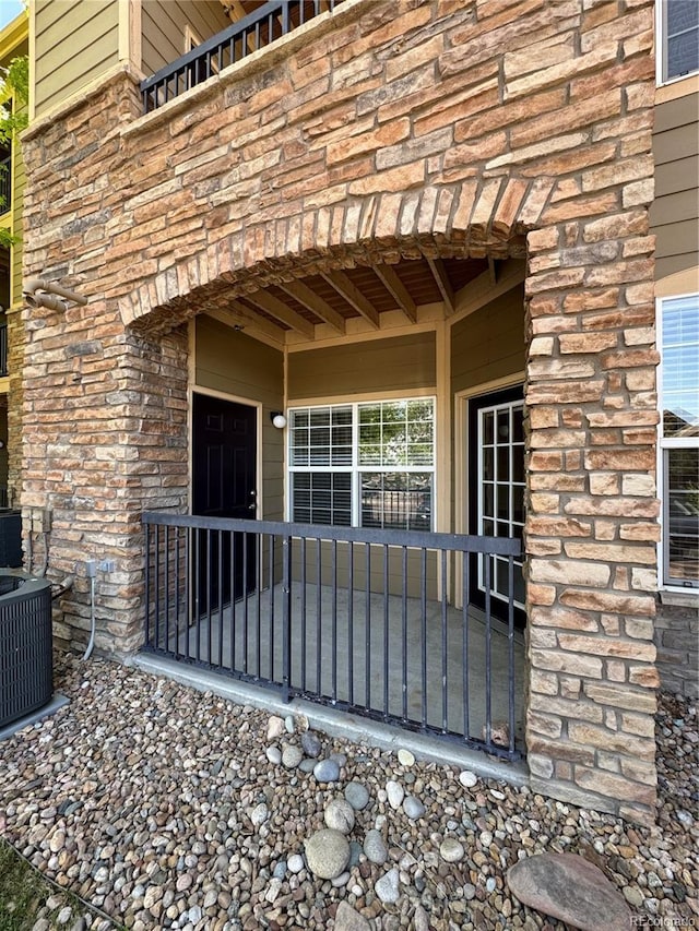 17346 Nature Walk Trl Unit 105, Parker, CO 80134 - view of exterior entry featuring stone siding and central AC