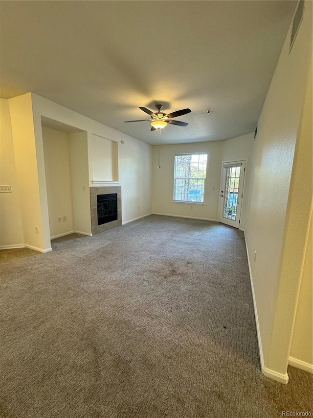 17346 Nature Walk Trl Unit 105, Parker, CO 80134 - unfurnished living room with carpet floors, baseboards, a ceiling fan, and a fireplace