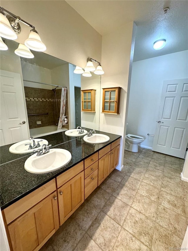 17346 Nature Walk Trl Unit 105, Parker, CO 80134 - bathroom with toilet, double vanity, baseboards, and tiled shower / bath combo