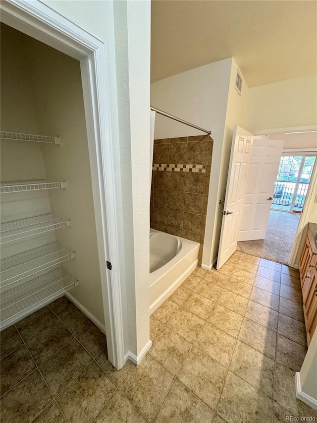 17346 Nature Walk Trl Unit 105, Parker, CO 80134 - bathroom with tub / shower combination, baseboards, and vanity