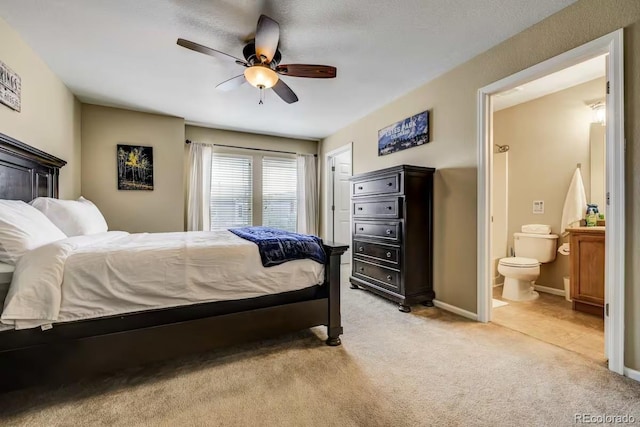 carpeted bedroom with ceiling fan and connected bathroom