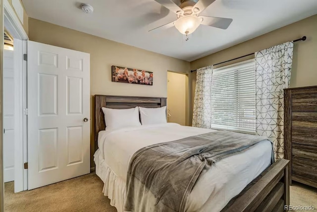 bedroom featuring light carpet and ceiling fan