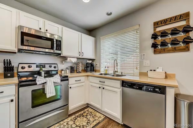 kitchen with sink, white cabinets, and appliances with stainless steel finishes