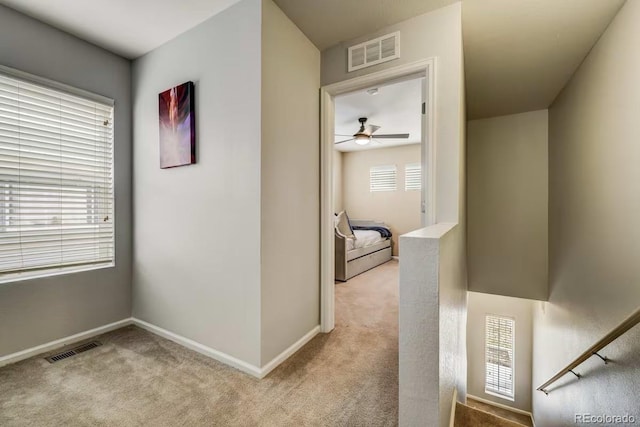 hallway with light colored carpet