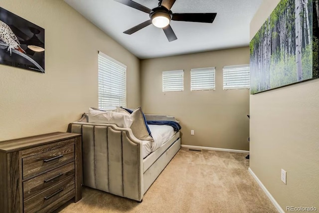 bedroom featuring light carpet and ceiling fan