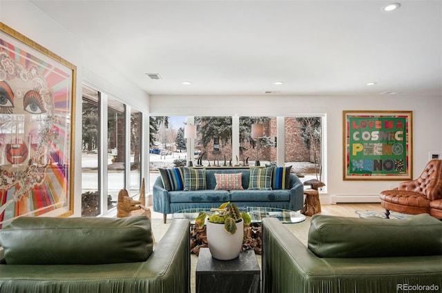 living area featuring visible vents, baseboard heating, wood finished floors, and recessed lighting