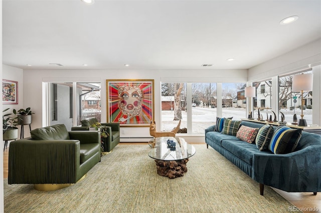 living room featuring a baseboard radiator, visible vents, and recessed lighting