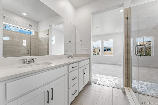 bathroom featuring an enclosed shower, vanity, and tile patterned flooring