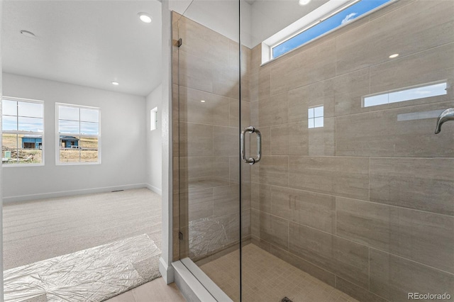 bathroom featuring a shower with shower door and tile patterned floors