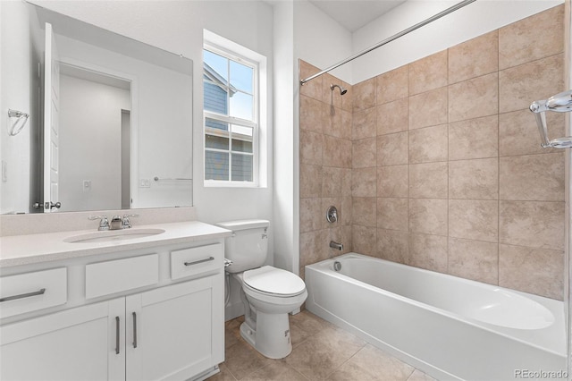 full bathroom with tiled shower / bath combo, vanity, toilet, and tile patterned flooring