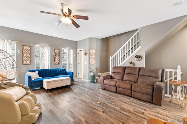 997 Burning Bush Pt, Monument, CO 80132 - living room featuring ceiling fan, wood finished floors, stairway, and baseboards