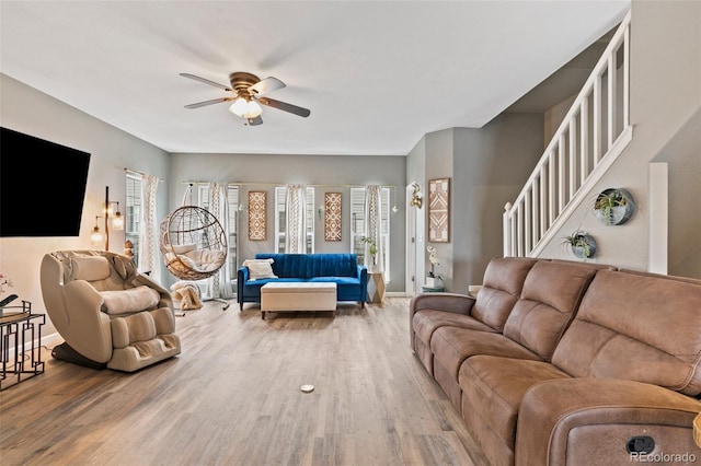 997 Burning Bush Pt, Monument, CO 80132 - living room featuring ceiling fan, wood finished floors, baseboards, and stairway