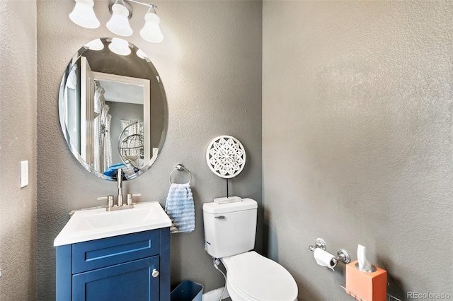 997 Burning Bush Pt, Monument, CO 80132 - bathroom with toilet, vanity, and a textured wall