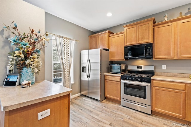 997 Burning Bush Pt, Monument, CO 80132 - kitchen with stainless steel appliances, light wood-type flooring, light countertops, and recessed lighting