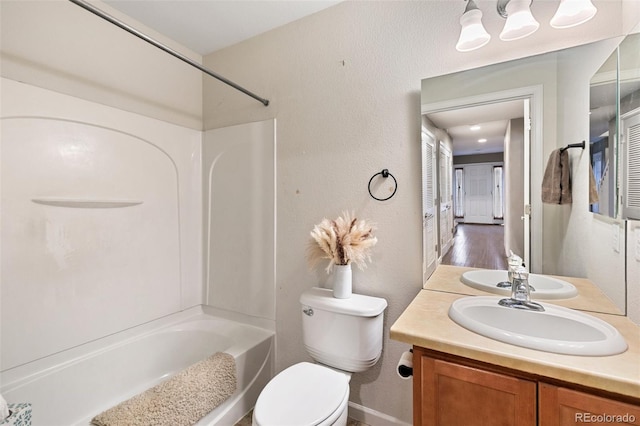 997 Burning Bush Pt, Monument, CO 80132 - bathroom with vanity, bathing tub / shower combination, toilet, a textured wall, and baseboards