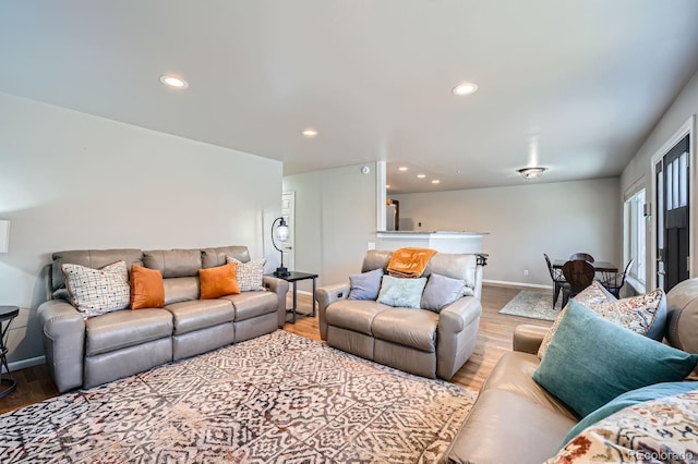 living area with recessed lighting, baseboards, and wood finished floors