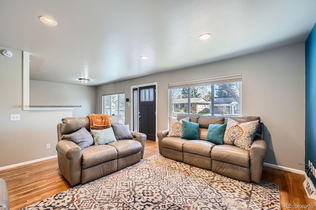 living room featuring recessed lighting, baseboards, and wood finished floors