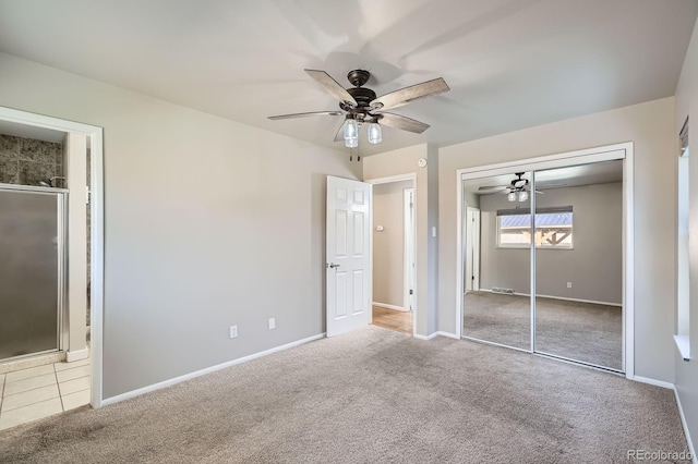 unfurnished bedroom with a closet, ensuite bath, a ceiling fan, carpet flooring, and baseboards