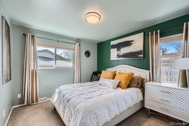 bedroom with baseboards and carpet floors
