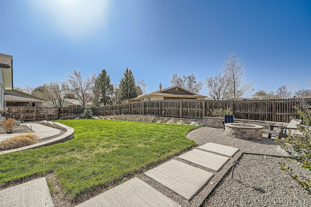 view of yard with an outdoor fire pit and a fenced backyard