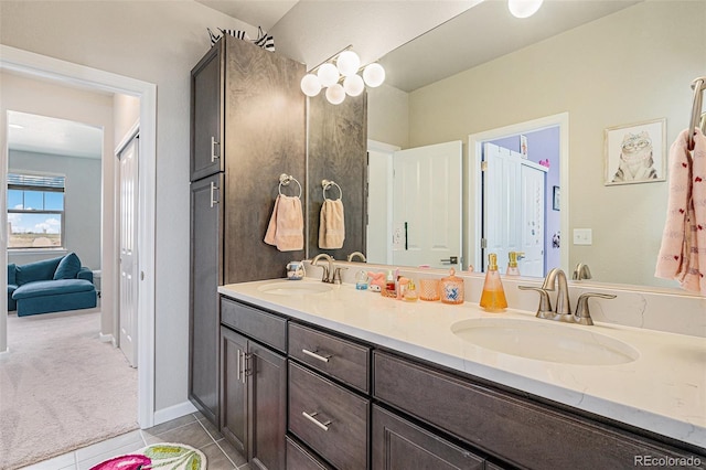 4532 Dewey Ln, Brighton, CO 80603 - bathroom with double vanity and tile patterned floors
