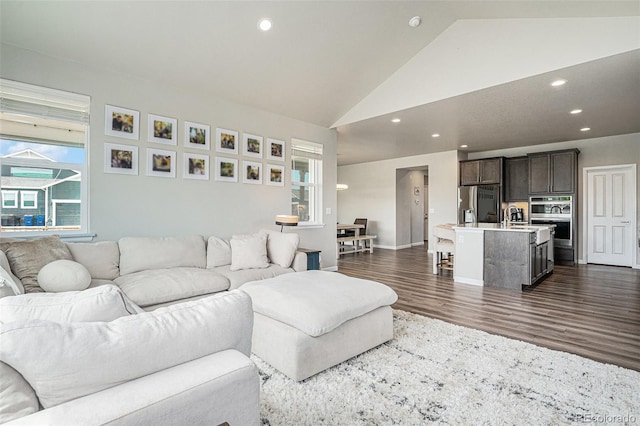 4532 Dewey Ln, Brighton, CO 80603 - living room featuring lofted ceiling, dark wood-type flooring, recessed lighting, and baseboards