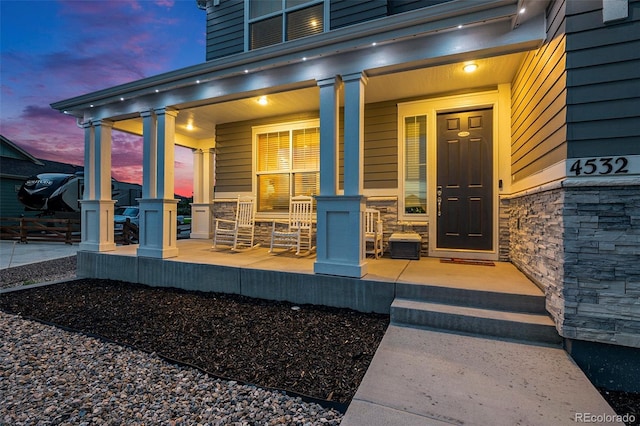 4532 Dewey Ln, Brighton, CO 80603 - entrance to property featuring covered porch and stone siding