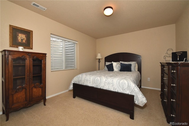 bedroom featuring light carpet, visible vents, and baseboards