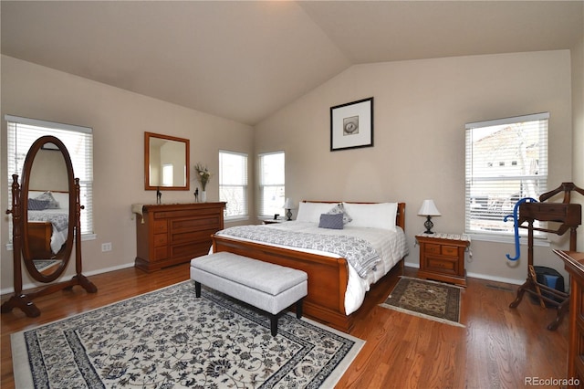 bedroom featuring dark wood-style flooring, multiple windows, and lofted ceiling