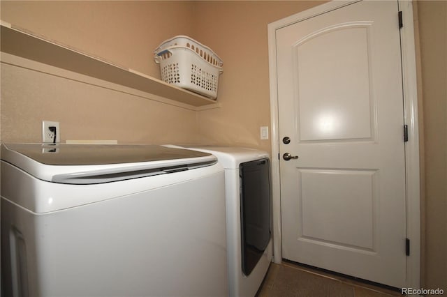 washroom with washing machine and clothes dryer and laundry area