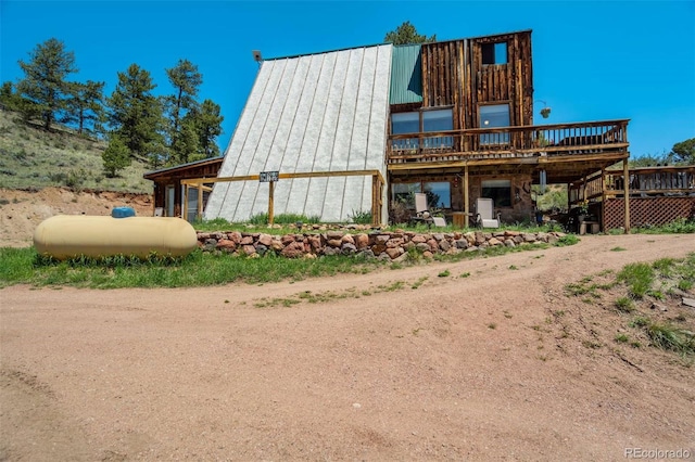 351 Badger Cir, Guffey, CO 80820 - view of front of home with a wooden deck, a standing seam roof, and a metal roof