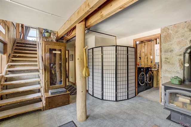 351 Badger Cir, Guffey, CO 80820 - basement with independent washer and dryer, tile patterned floors, a wood stove, and stairway