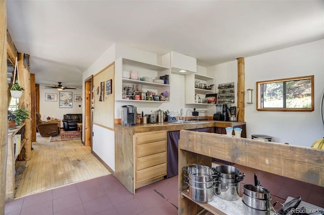 351 Badger Cir, Guffey, CO 80820 - kitchen with open shelves, ceiling fan, and light tile patterned flooring