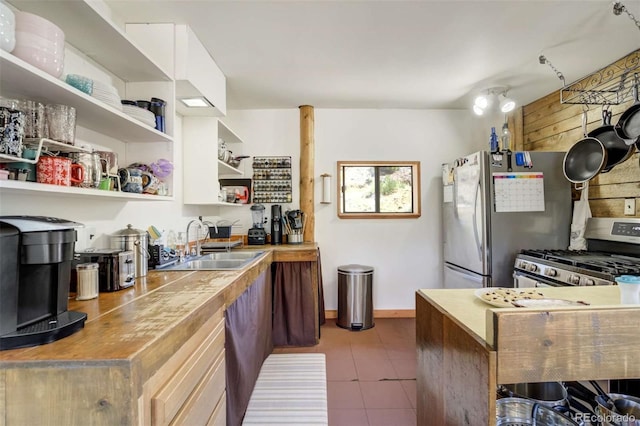 351 Badger Cir, Guffey, CO 80820 - kitchen with appliances with stainless steel finishes, open shelves, and tile patterned floors