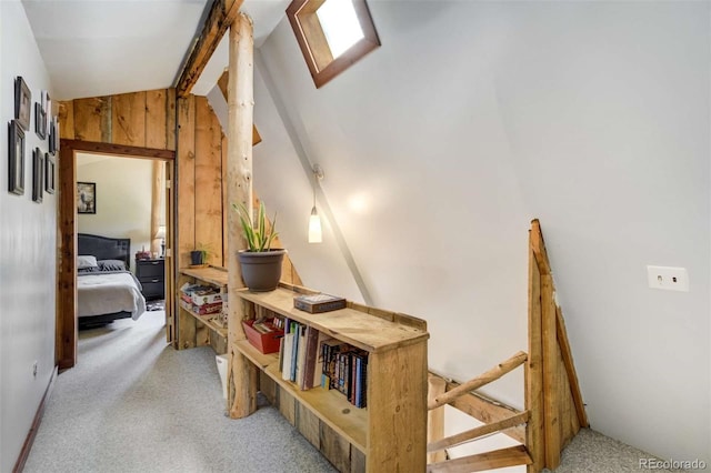 351 Badger Cir, Guffey, CO 80820 - hall with light carpet, vaulted ceiling, and wood walls