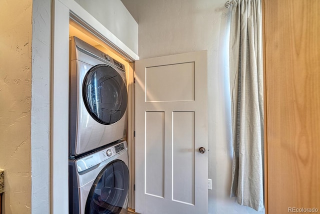 121 Halleys Ave Unit D, Poncha Springs, CO 81242 - laundry area with stacked washer and dryer, a textured wall, and laundry area