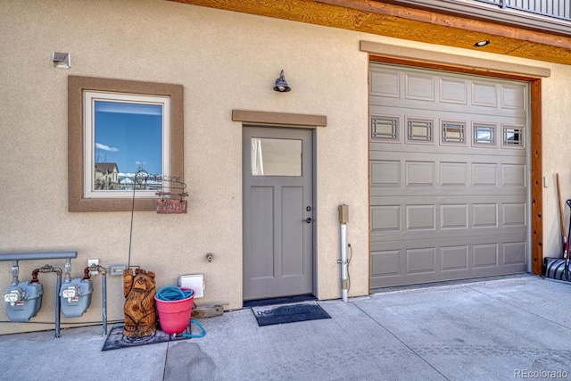 121 Halleys Ave Unit D, Poncha Springs, CO 81242 - entrance to property featuring a garage, driveway, and stucco siding