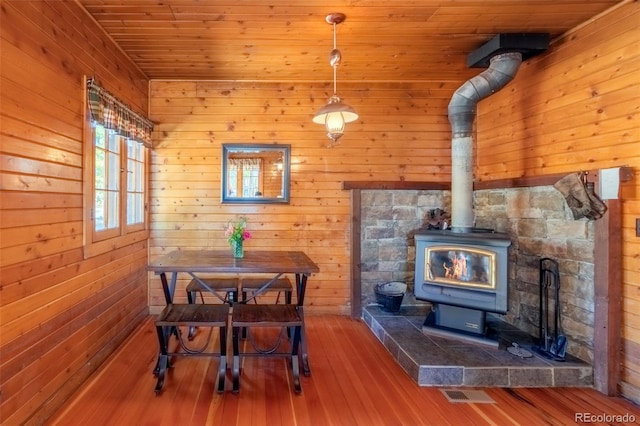 1348 Gcr 64, Grand Lake, CO 80447 - dining space featuring a wood stove, hardwood / wood-style flooring, wood walls, and wood ceiling