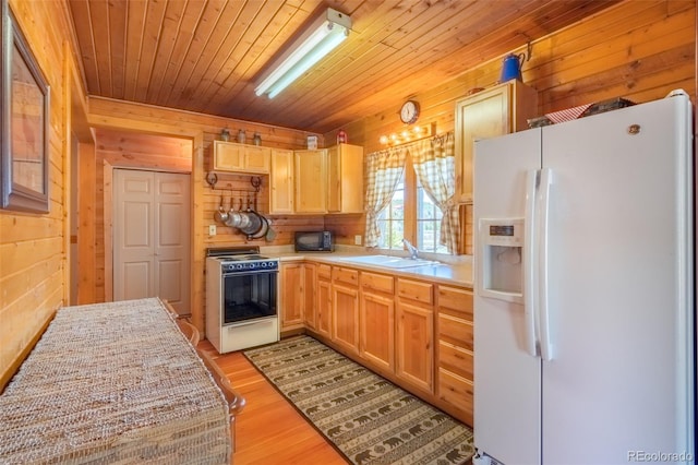1348 Gcr 64, Grand Lake, CO 80447 - kitchen with white refrigerator with ice dispenser, range, a sink, wooden walls, and light countertops